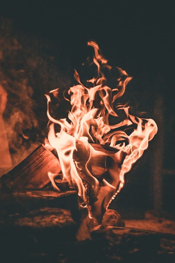 a fire burning in a fireplace with a black background
