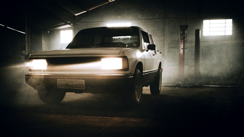 a white truck parked in a dark garage