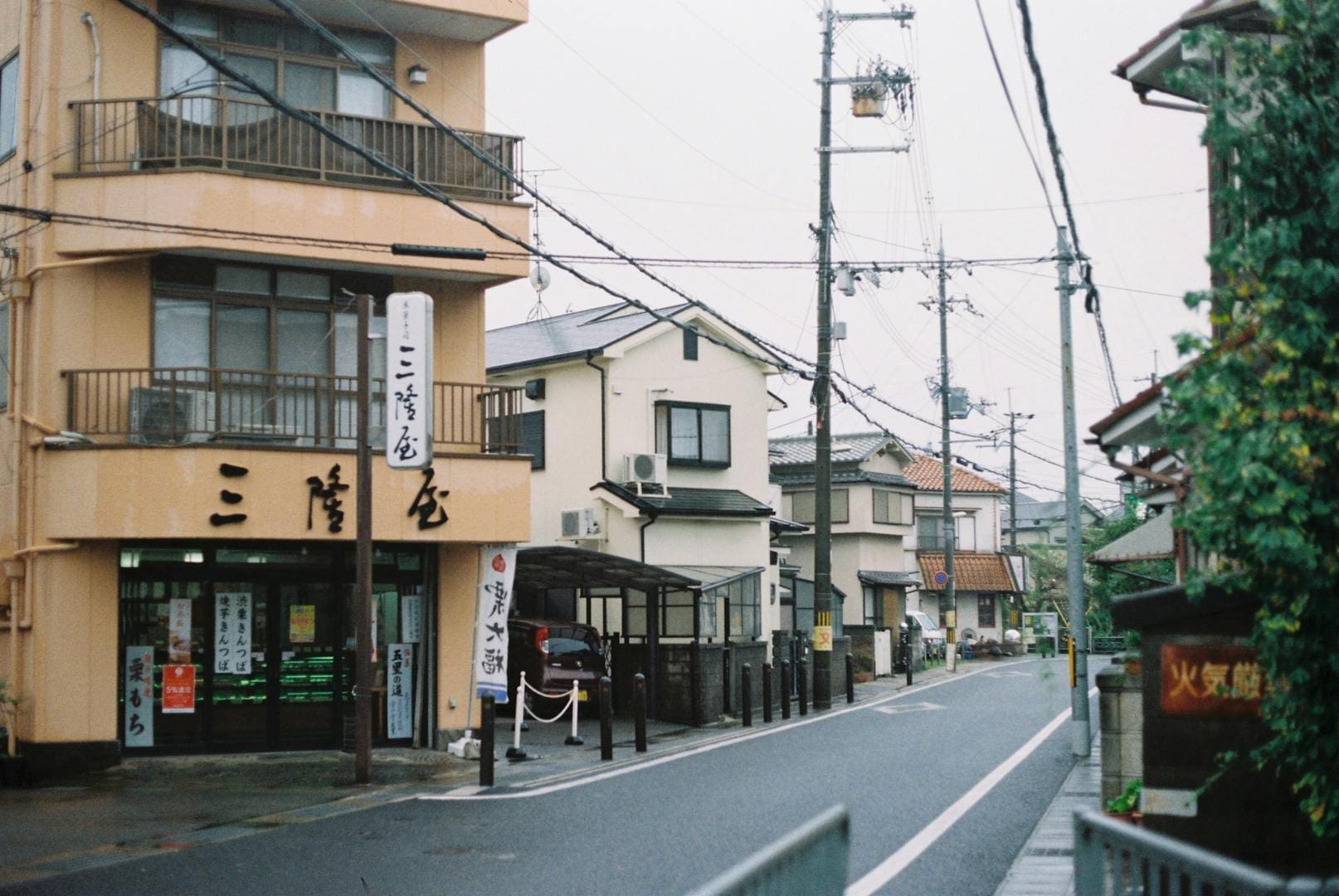 A peaceful street in Japan showcasing traditional architecture and urban life.