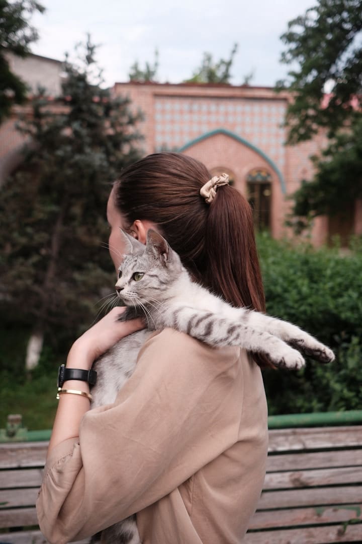 A woman holding a cat in her arms